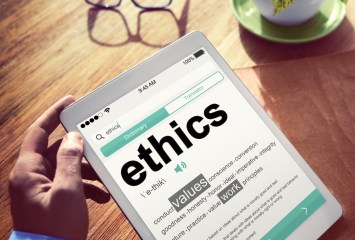 Man Reading the Definition of Ethics